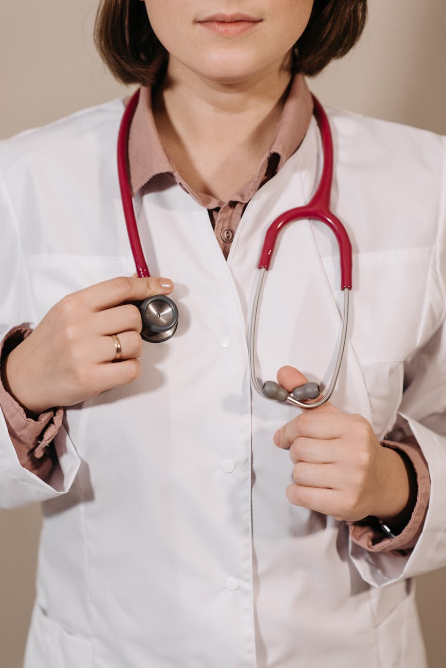 physician in white coat wearing a stethoscope