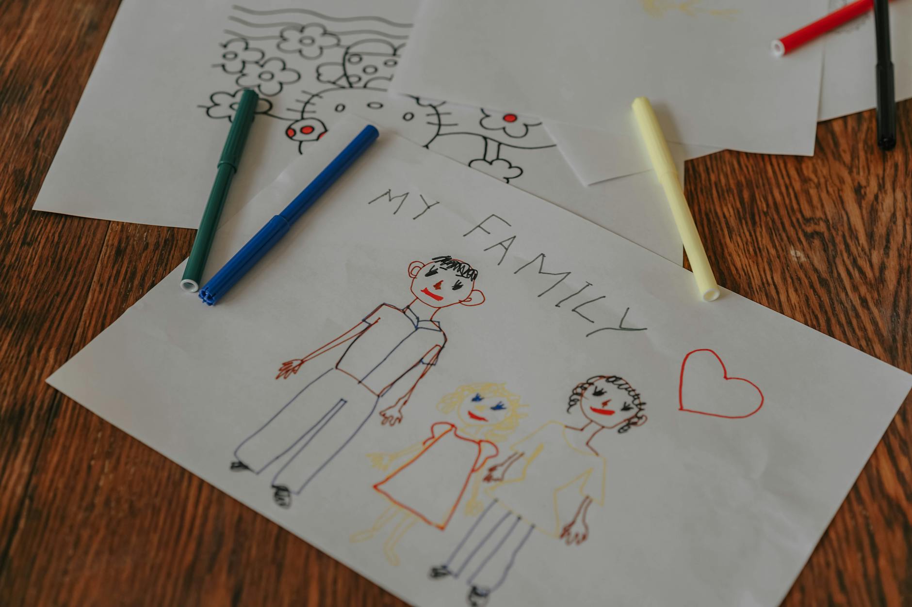 close up of a child s drawing of a family on paper